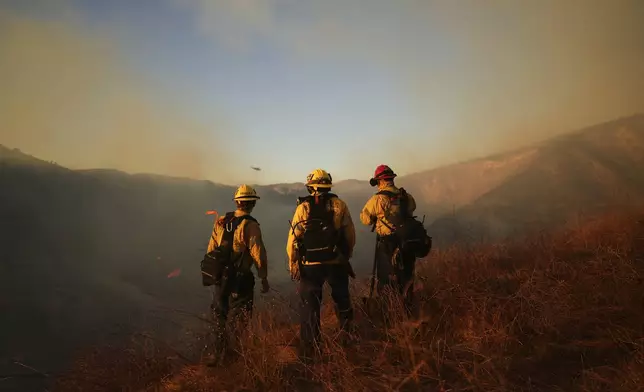 Firefighters look out over the Kenneth Fire, Thursday, Jan. 9, 2025, in the West Hills section of Los Angeles. (AP Photo/Eric Thayer)