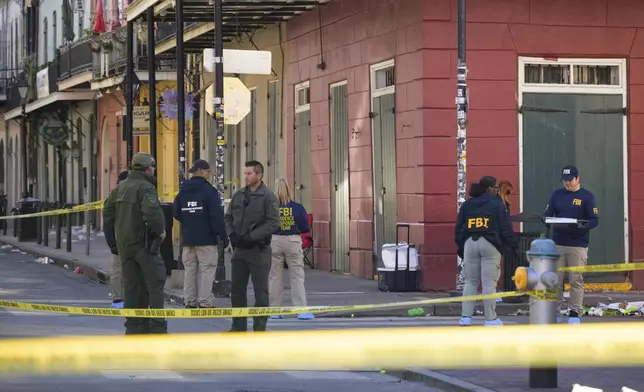 The FBI investigates the area on Orleans St and Bourbon Street by St. Louis Cathedral in the French Quarter where a suspicious package was detonated after a person drove a truck into a crowd earlier on Bourbon Street on Wednesday, Jan. 1, 2025. (AP Photo/Matthew Hinton)