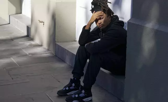 Trevant Hayes, 20, sits in the French Quarter after the death of his friend, Nikyra Dedeaux, 18, after a pickup truck crashed into pedestrians on Bourbon Street followed by a shooting in the French Quarter in New Orleans, Wednesday, Jan. 1, 2025. (AP Photo/Matthew Hinton)