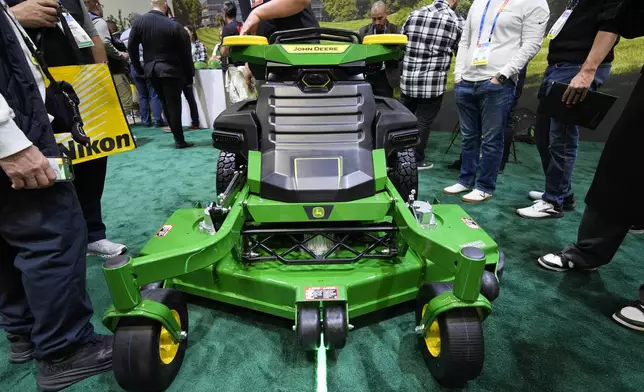 People view an autonomous lawn mower at the John Deere booth during the CES tech show Tuesday, Jan. 7, 2025, in Las Vegas. (AP Photo/John Locher)