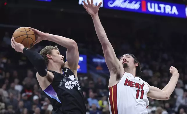 Utah Jazz forward Lauri Markkanen, left, and Miami Heat guard Jaime Jaquez Jr. (11) battle for a rebound during the first half of an NBA basketball game, Thursday, Jan. 9, 2025, in Salt Lake City. (AP Photo/Rob Gray)