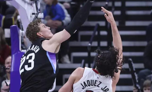 Utah Jazz forward Lauri Markkanen (23) blocks a shot by Miami Heat guard Jaime Jaquez Jr. (11) during the second half of an NBA basketball game, Thursday, Jan. 9, 2025, in Salt Lake City. (AP Photo/Rob Gray)