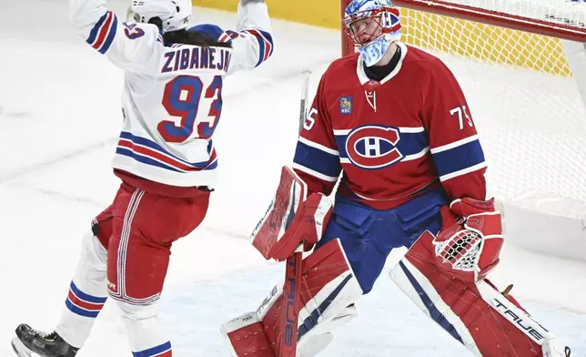New York Rangers' Mika Zibaneja ,93, reacts to a goal by teammate Will Cuylle,,as Montreal Canadiens goaltender Jakub Dobes (75) reacts during the first period NHL hockey action in Montreal, Sunday, Jan. 19, 2025. Graham Hughes/The Canadian Press via AP)
