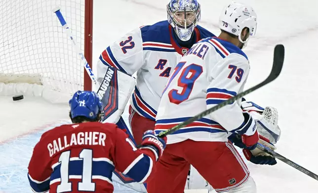 Montreal Canadiens' Brendan Gallagher (11) scores on New York Rangers goaltender Jonathan Quick as Rangers' K'Andre Miller (79) defends during the first period of an NHL hockey game in Montreal, Sunday, Jan. 19, 2025. Graham Hughes/The Canadian Press via AP)
