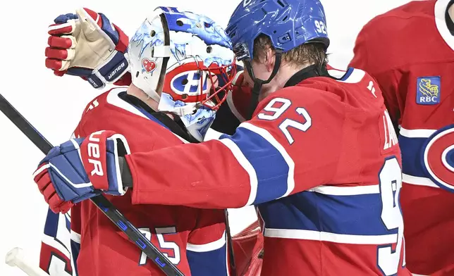 Montreal Canadiens' Patrik Laine (92) embraces goalie Jakub Dobes, left, after defeating the New York Rangers in an NHL hockey game in Montreal, Sunday, Jan. 19, 2025. (Graham Hughes/The Canadian Press via AP)