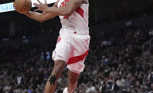 Toronto Raptors forward Scottie Barnes dunks the ball during the first half of an NBA basketball game in Toronto, Monday, Jan. 6, 2025. (Nathan Denette/The Canadian Press via AP)