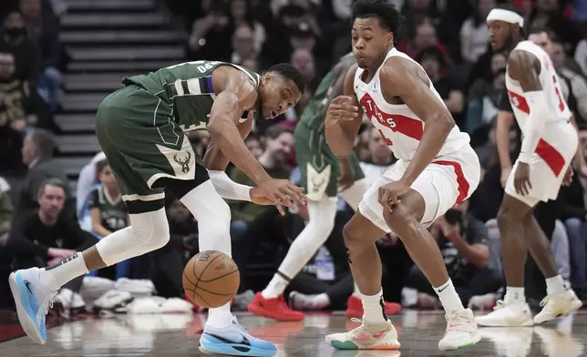 Toronto Raptors forward Scottie Barnes steals the ball from Milwaukee Bucks forward Giannis Antetokounmpo during the first half of an NBA basketball game in Toronto, Monday, Jan. 6, 2025. (Nathan Denette/The Canadian Press via AP)