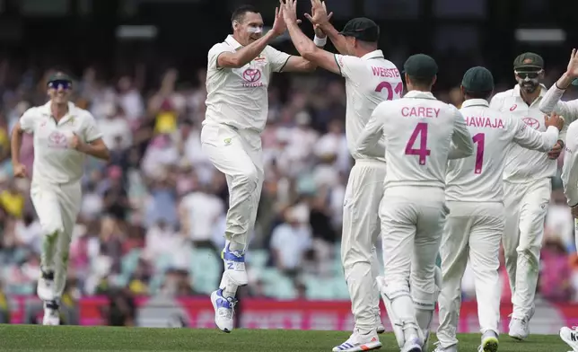 Australia's Scott Boland celebrates with teammates after taking the wicket India's Nitish Kumar Reddy during play on the first day of the fifth cricket test between India and Australia at the Sydney Cricket Ground, in Sydney, Australia, Friday, Jan. 3, 2025. (AP Photo/Mark Baker)