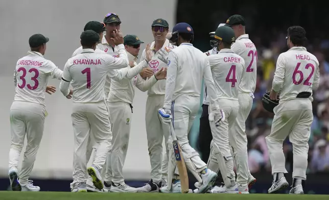 Australia players celebrate after taking the wicket of India's Shubman Gill, during play on the first day of the fifth cricket test between India and Australia at the Sydney Cricket Ground, in Sydney, Australia, Friday, Jan. 3, 2025. (AP Photo/Mark Baker)