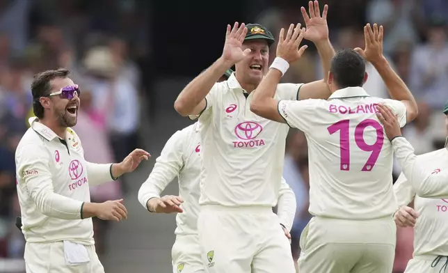 Australia's Beau Webster, centre, is congratulated by teammates after taking a catch to dismiss India's Yashasvi Jaiswal during play on the first day of the fifth cricket test between India and Australia at the Sydney Cricket Ground, in Sydney, Australia, Friday, Jan. 3, 2025. (AP Photo/Mark Baker)