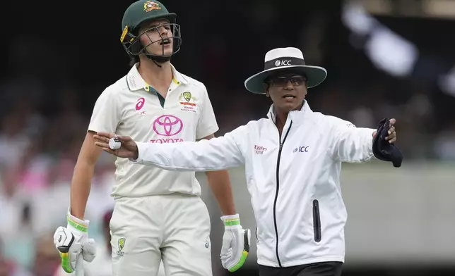 Umpire Sharfuddoula Saikat, right, gestures Australia's Sam Konstas exchanges words with to India's Jasprit Bumrah, not pictured, during play on the first day of the fifth cricket test between India and Australia at the Sydney Cricket Ground, in Sydney, Australia, Friday, Jan. 3, 2025. (AP Photo/Mark Baker)