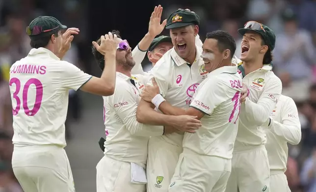 Australia's Beau Webster, centre, is congratulated by teammates after taking a catch to dismiss India's Yashasvi Jaiswal during play on the first day of the fifth cricket test between India and Australia at the Sydney Cricket Ground, in Sydney, Australia, Friday, Jan. 3, 2025. (AP Photo/Mark Baker)