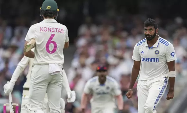 India's Jasprit Bumra, right, reacts with Australia's Sam Konstas, left, after taking the wicket of Australia's Usman Khawaja during play on the first day of the fifth cricket test between India and Australia at the Sydney Cricket Ground, in Sydney, Australia, Friday, Jan. 3, 2025. (AP Photo/Mark Baker)