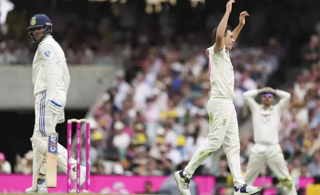 Australia's captain Pat Cummins, right, reacts after bowling to India's Shubman Gill during play on the first day of the fifth cricket test between India and Australia at the Sydney Cricket Ground, in Sydney, Australia, Friday, Jan. 3, 2025. (AP Photo/Mark Baker)