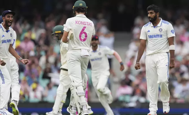 India's Jasprit Bumra, right, reacts with Australia's Sam Konstas, left, after taking the wicket of Australia's Usman Khawaja during play on the first day of the fifth cricket test between India and Australia at the Sydney Cricket Ground, in Sydney, Australia, Friday, Jan. 3, 2025. (AP Photo/Mark Baker)