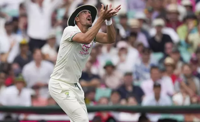 Australia's Mitchell Starc takes a catch to dismiss India's Jasprit Bumrah during play on the first day of the fifth cricket test between India and Australia at the Sydney Cricket Ground, in Sydney, Australia, Friday, Jan. 3, 2025. (AP Photo/Mark Baker)