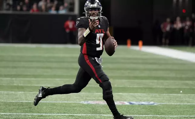 Atlanta Falcons quarterback Michael Penix Jr. runs against the Carolina Panthers during the second half of an NFL football game, Sunday, Jan. 5, 2025, in Atlanta. (AP Photo/Mike Stewart)