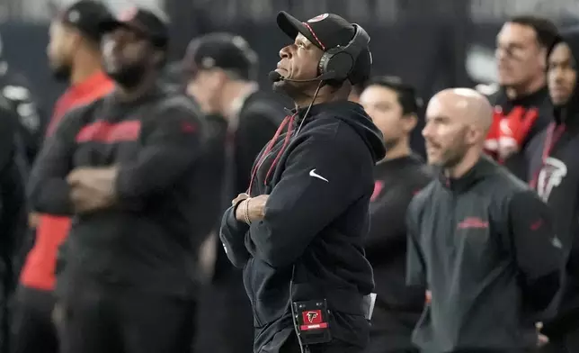 Atlanta Falcons head coach Raheem Morris watches during the first half of an NFL football game against the Carolina Panthers, Sunday, Jan. 5, 2025, in Atlanta. (AP Photo/Mike Stewart)