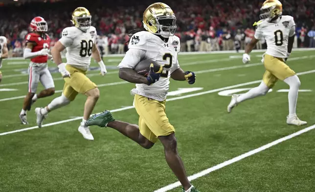 Notre Dame's Jayden Harrison (2) returns a kickoff 98 yards for a touchdown during the second half against Georgia in the quarterfinals of a College Football Playoff, Thursday, Jan. 2, 2025, in New Orleans. (AP Photo/Matthew Hinton)