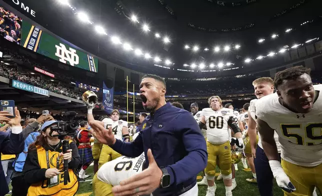 Notre Dame head coach Marcus Freeman celebrates with fans after quarterfinal game against Georgia in a College Football Playoff, Thursday, Jan. 2, 2025, in New Orleans. (AP Photo/Gerald Herbert)