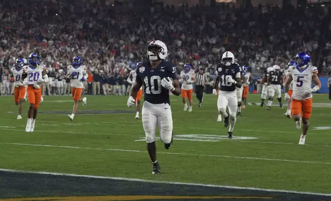 Penn State running back Nicholas Singleton (10) scores a touchdown against Boise State during the second half of the Fiesta Bowl College Football Playoff game, Tuesday, Dec. 31, 2024, in Glendale, Ariz. (AP Photo/Rick Scuteri)