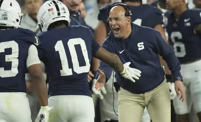 Penn State head coach James Franklin, right celebrates with running back Nicholas Singleton (10) after a touchdown during the second half of the Fiesta Bowl College Football Playoff game against Boise State, Tuesday, Dec. 31, 2024, in Glendale, Ariz. (AP Photo/Ross D. Franklin)