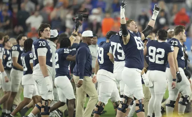 Penn State players celebrate after the Fiesta Bowl College Football Playoff game against Boise State, Tuesday, Dec. 31, 2024, in Glendale, Ariz. (AP Photo/Ross D. Franklin)