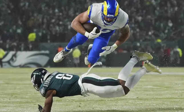 Los Angeles Rams tight end Tyler Higbee (89) is stopped by Philadelphia Eagles safety C.J. Gardner-Johnson (8) during the second half of an NFL football NFC divisional playoff game Sunday, Jan. 19, 2025, in Philadelphia. (AP Photo/Matt Slocum)