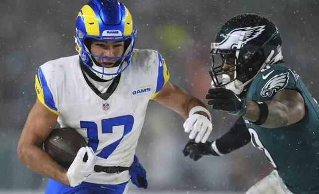Los Angeles Rams wide receiver Puka Nacua (17) runs with the ball as Philadelphia Eagles safety C.J. Gardner-Johnson (8) tries to stop him during the second half of an NFL football NFC divisional playoff game Sunday, Jan. 19, 2025, in Philadelphia. (AP Photo/Derik Hamilton)