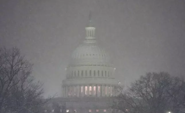 The Capitol is pictured as snow falls ahead of a joint session of Congress to certify the votes from the Electoral College in the presidential election in Washington, Monday, Jan. 6, 2025. (AP Photo/Matt Rourke)