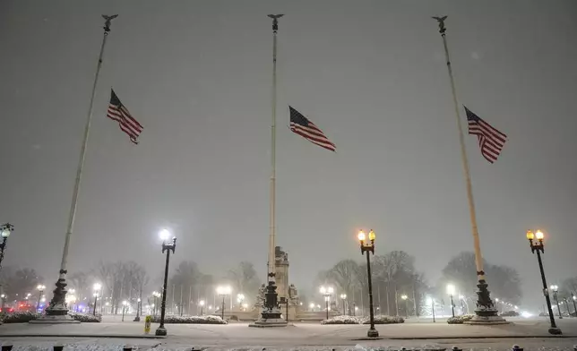 Flags fly at half-staff in memorial to former President Jimmy Carter during a winter snow storm at Union Station in Washington, Monday, Jan. 6, 2025. Carter died at age 100. (AP Photo/Matt Rourke)