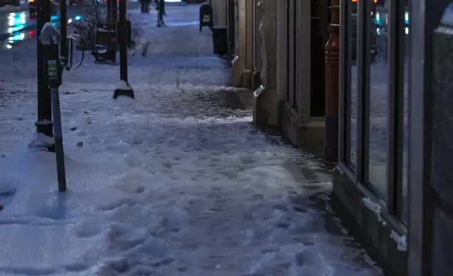 Ice and snow cover a sidewalk in downtown Lexington, Ky., on Monday, Jan. 6, 2025. (Ryan C. Hermens/Lexington Herald-Leader via AP)