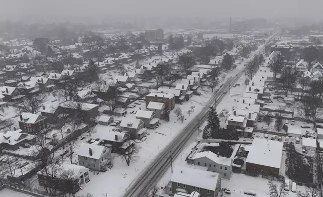 Snow covers homes during a winter storm, Monday, Jan. 6, 2025, in Cincinnati. (AP Photo/Joshua A. Bickel)