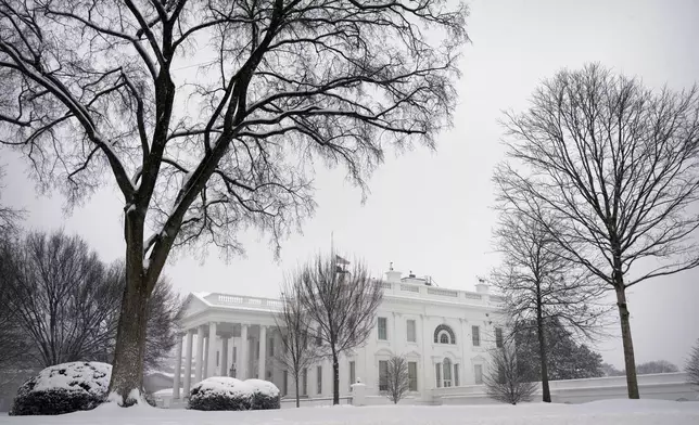 Snow falls during a winter storm at the White House, Monday, Jan. 6, 2025, in Washington. (AP Photo/Mark Schiefelbein)