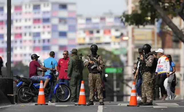 Security forces stand guard ahead of President Nicolas Maduro's swearing-in for a third term, in Caracas, Venezuela, Sunday, Jan. 5, 2025. (AP Photo/Matias Delacroix)