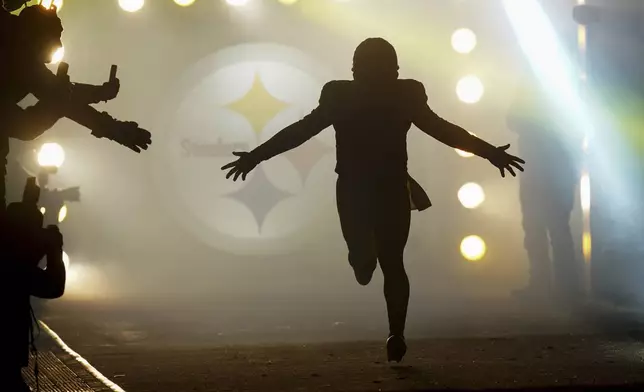 Pittsburgh Steelers quarterback Russell Wilson runs onto the field as he is introduced before an NFL football game against the Cincinnati Bengals in Pittsburgh, Saturday, Jan. 4, 2025. (AP Photo/Matt Freed)