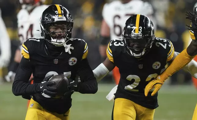 Pittsburgh Steelers cornerback Beanie Bishop Jr. (31) celebrates an interception with safety Damontae Kazee (23) during the first half of an NFL football game against the Cincinnati Bengals in Pittsburgh, Saturday, Jan. 4, 2025. (AP Photo/Matt Freed)