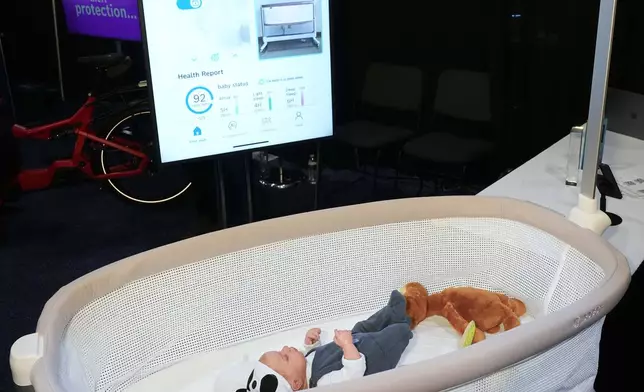 Bosch showcases the Revol Intelligent Crib, which monitors the baby's vital signs and can automatically rock if the baby is crying, during 2025 CES Unveiled, Sunday, Jan. 5, 2025, in Las Vegas. (AP Photo/Jack Dempsey)