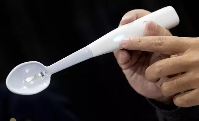 The Kirin Electric Salt spoon flows a mild electric current through the food around the tongue to attract salt towards the tongue creating a more intense salt flavor, during 2025 CES Unveiled, Sunday, Jan. 5, 2025, in Las Vegas. (AP Photo/Jack Dempsey)