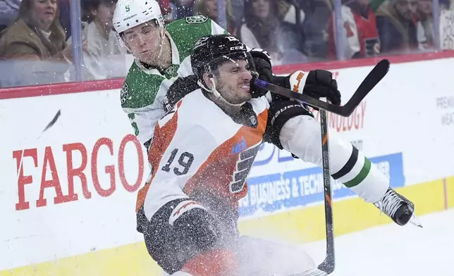 Philadelphia Flyers' Garnet Hathaway (19) and Dallas Stars' Nils Lundkvist (5) collide during the second period of an NHL hockey game, Thursday, Jan. 9, 2025, in Philadelphia. (AP Photo/Matt Slocum)