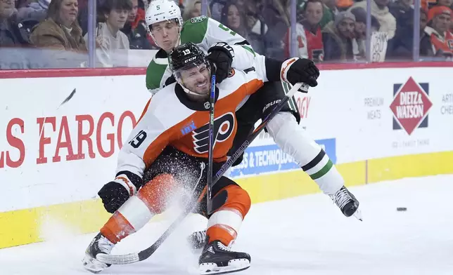 Philadelphia Flyers' Garnet Hathaway (19) and Dallas Stars' Nils Lundkvist (5) collide during the second period of an NHL hockey game, Thursday, Jan. 9, 2025, in Philadelphia. (AP Photo/Matt Slocum)