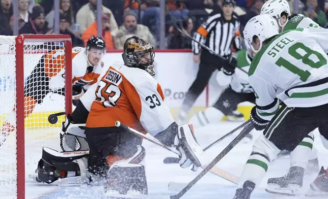 Philadelphia Flyers' Samuel Ersson (33) cannot stop a goal by Dallas Stars' Mavrik Bourque (22) during the first period of an NHL hockey game, Thursday, Jan. 9, 2025, in Philadelphia. (AP Photo/Matt Slocum)