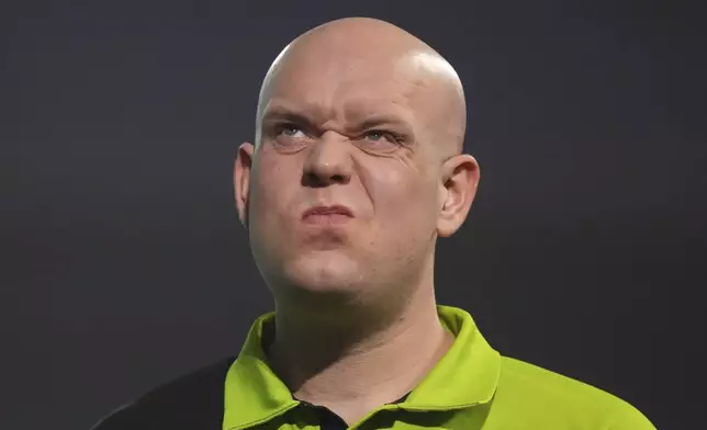 Michael van Gerwen of the Netherlands reacts during the final of the World Darts Championship at Alexandra Palace in London, Friday, Jan. 3, 2025. (AP Photo/Kirsty Wigglesworth)