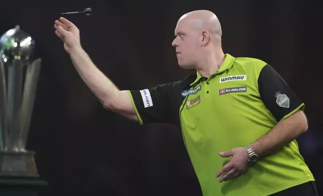 Michael van Gerwen of the Netherlands throws his dart during the final of the World Darts Championship at Alexandra Palace in London, Friday, Jan. 3, 2025. (AP Photo/Kirsty Wigglesworth)