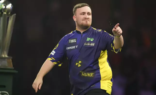 Luke Littler of England celebrates during the final of the World Darts Championship at Alexandra Palace in London, Friday, Jan. 3, 2025. (AP Photo/Kirsty Wigglesworth)