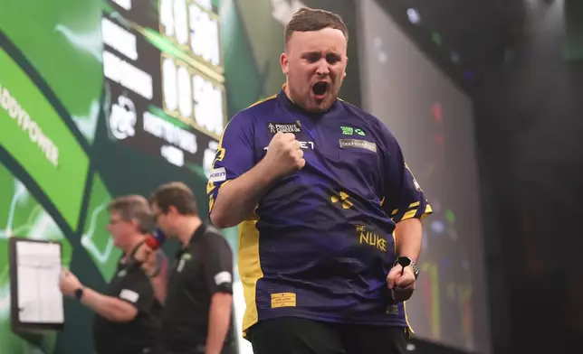 Luke Littler of England celebrates during the final of the World Darts Championship at Alexandra Palace in London, Friday, Jan. 3, 2025. (AP Photo/Kirsty Wigglesworth)