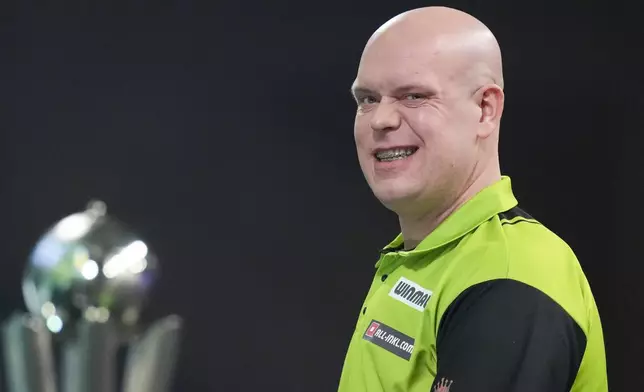 Michael van Gerwen of the Netherlands grimaces during the final of the World Darts Championship at Alexandra Palace in London, Friday, Jan. 3, 2025. (AP Photo/Kirsty Wigglesworth)