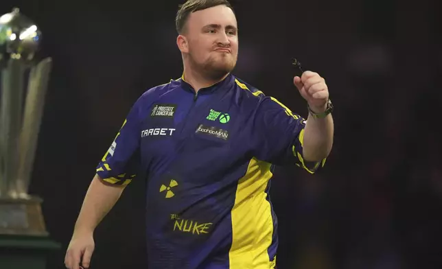 Luke Littler of England celebrates during the final of the World Darts Championship at Alexandra Palace in London, Friday, Jan. 3, 2025. (AP Photo/Kirsty Wigglesworth)