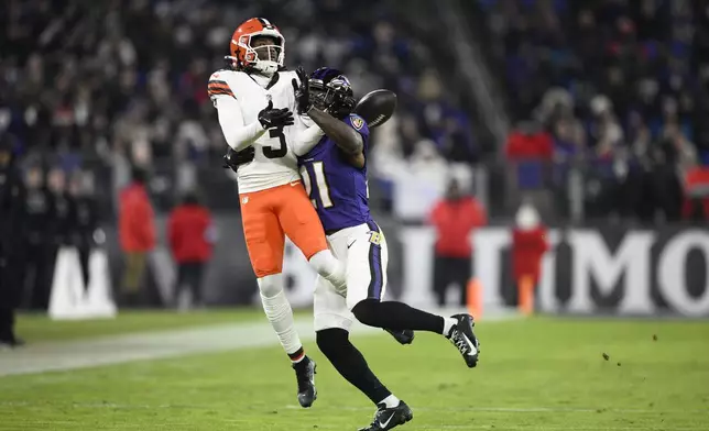 Baltimore Ravens defensive back Brandon Stephens (21) breaks up a pass intended for Cleveland Browns wide receiver Jerry Jeudy (3) during the first half of an NFL football game Saturday, Jan. 4, 2025, in Baltimore. (AP Photo/Nick Wass)