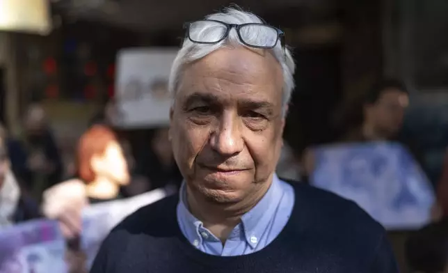 Syrian author Yassin Haj Saleh, husband of Samira Alkhalil, who disappeared during the war between opposition forces and Assad regime, takes part in a protest demanding answers to the whereabouts of her and other activists, in Douma, Syria, Wednesday, Jan. 1, 2025. (AP Photo/Mosa'ab Elshamy)